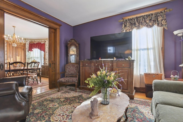 living room with a chandelier and light wood finished floors