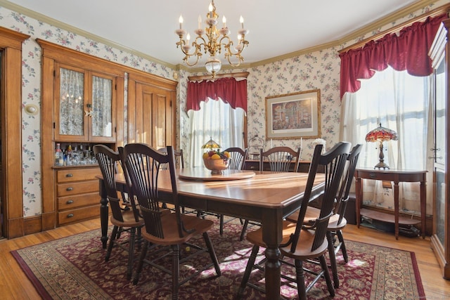 dining room featuring light wood-type flooring, a wealth of natural light, and wallpapered walls