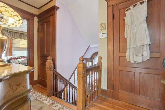 interior space with light wood-style floors, plenty of natural light, and ornamental molding