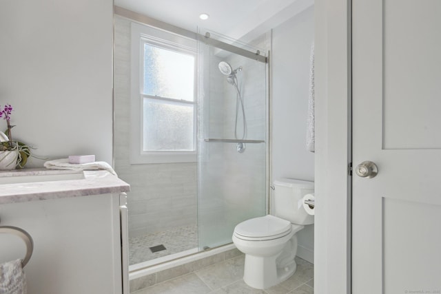 bathroom with toilet, tile patterned floors, a shower stall, and vanity