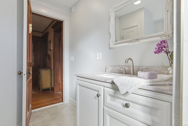 bathroom with tile patterned flooring, vanity, and baseboards