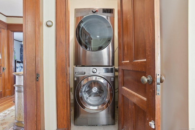 washroom featuring stacked washer and dryer and laundry area