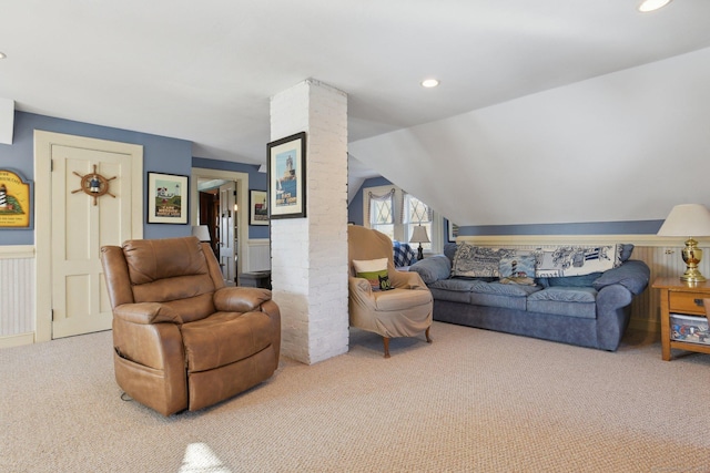 carpeted living room with lofted ceiling, ornate columns, wainscoting, and recessed lighting