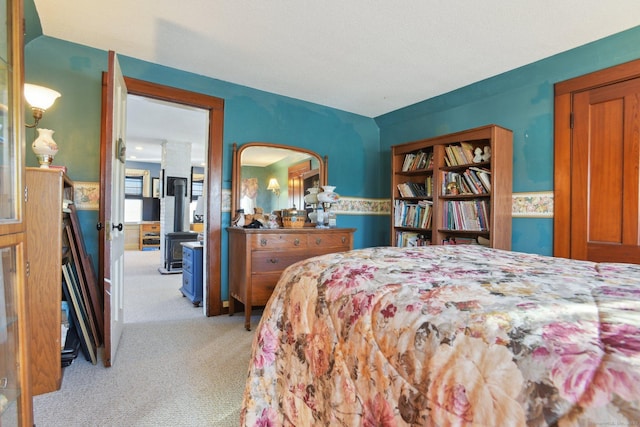 bedroom with wainscoting and light carpet