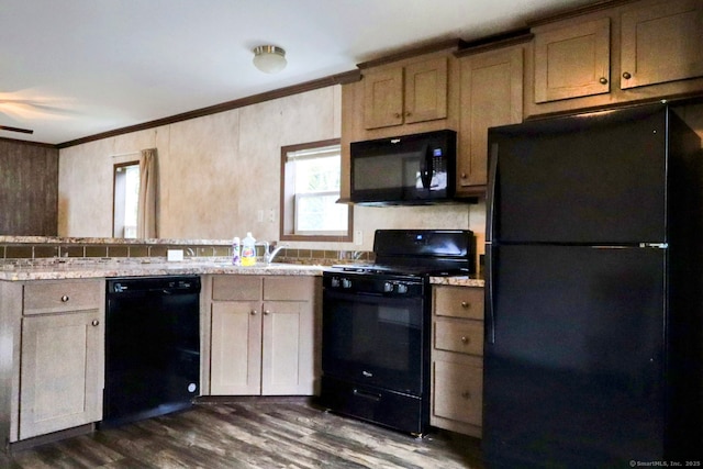 kitchen featuring dark wood-style flooring, light countertops, crown molding, black appliances, and a sink