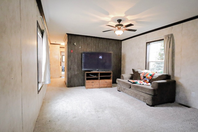 living room featuring carpet floors, visible vents, crown molding, and ceiling fan