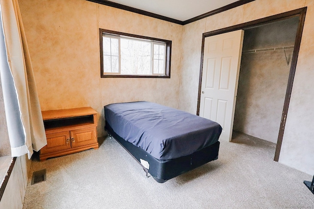 bedroom with light carpet, a closet, visible vents, and crown molding