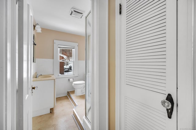 bathroom featuring tile patterned floors, vanity, and toilet