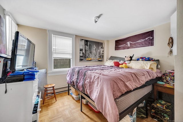 bedroom featuring a baseboard radiator and light parquet floors