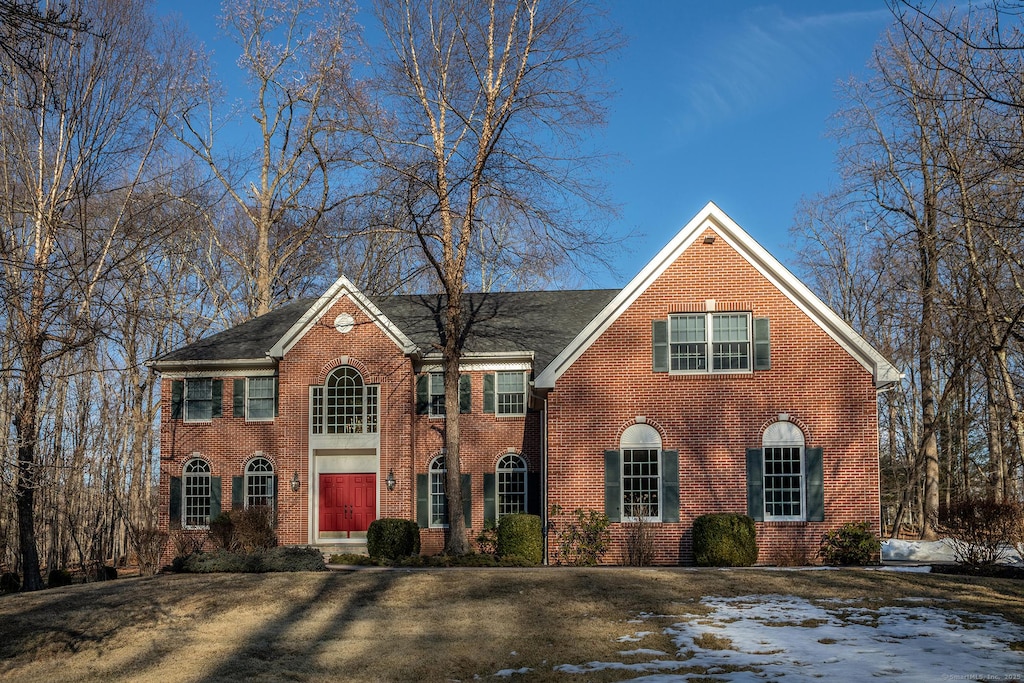 georgian-style home featuring brick siding