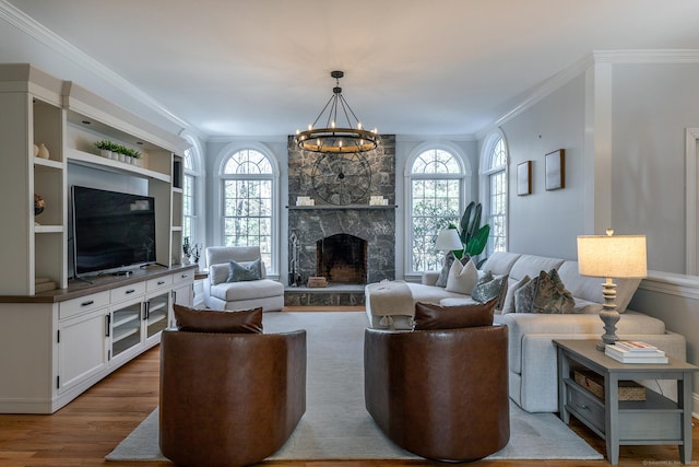 living area with ornamental molding, wood finished floors, and a wealth of natural light