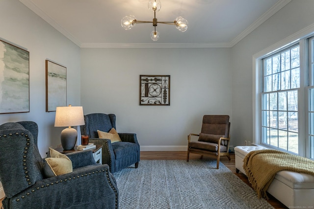 living area with a chandelier, a healthy amount of sunlight, crown molding, and wood finished floors