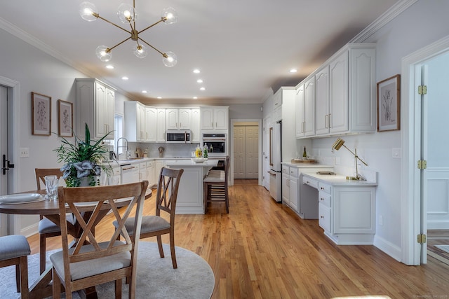 kitchen with ornamental molding, white appliances, light wood finished floors, and tasteful backsplash