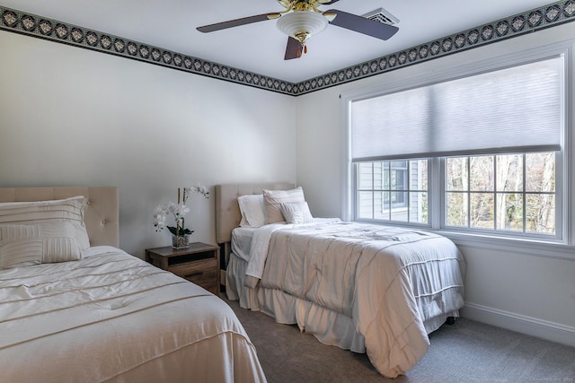 bedroom with a ceiling fan, carpet flooring, visible vents, and baseboards