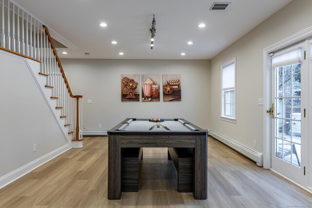 rec room with visible vents, a baseboard heating unit, light wood-style flooring, and recessed lighting