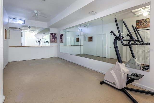 workout area with ceiling fan and baseboards