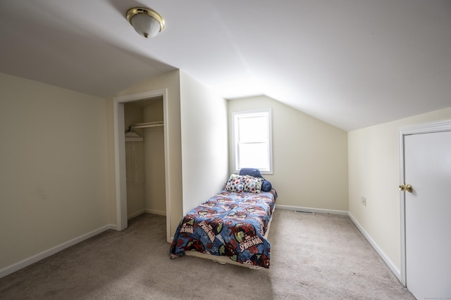 bedroom with carpet flooring, baseboards, and vaulted ceiling