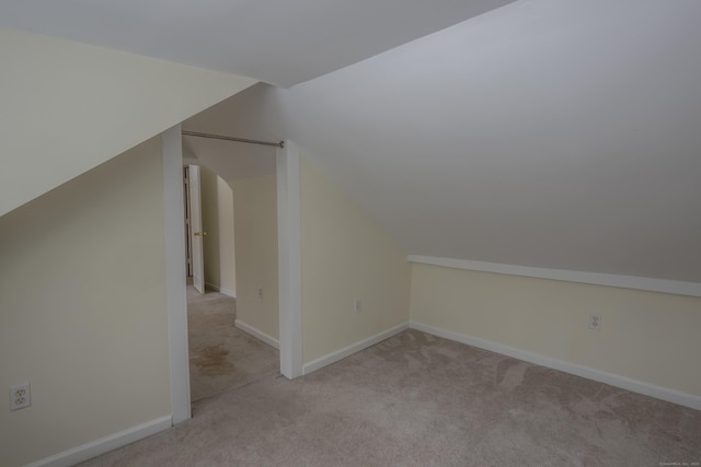 bonus room with lofted ceiling, carpet flooring, and baseboards