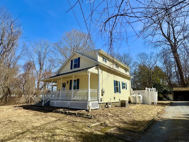 view of home's exterior featuring covered porch and central AC