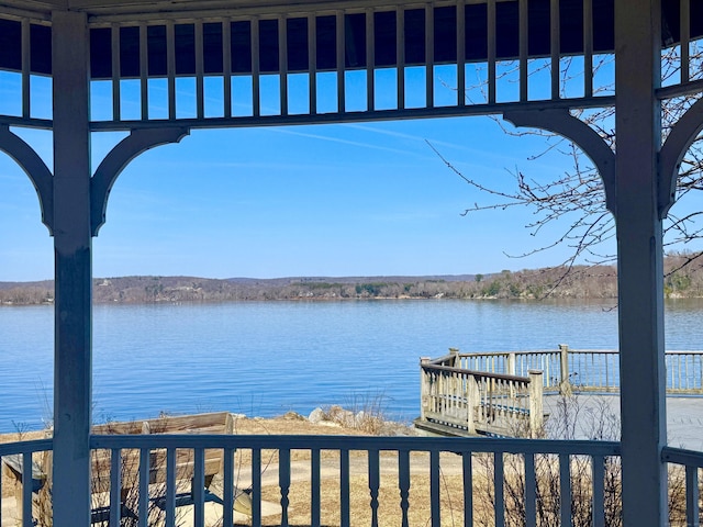 exterior space featuring a water view and fence