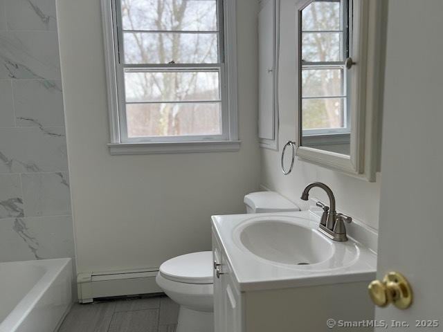 bathroom featuring a baseboard radiator, vanity, and toilet