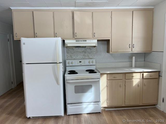 kitchen featuring white appliances and light wood-type flooring