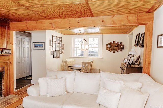 living room featuring wood ceiling, beam ceiling, a chandelier, and hardwood / wood-style floors