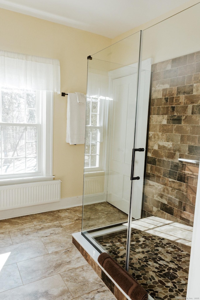 bathroom with radiator heating unit and an enclosed shower