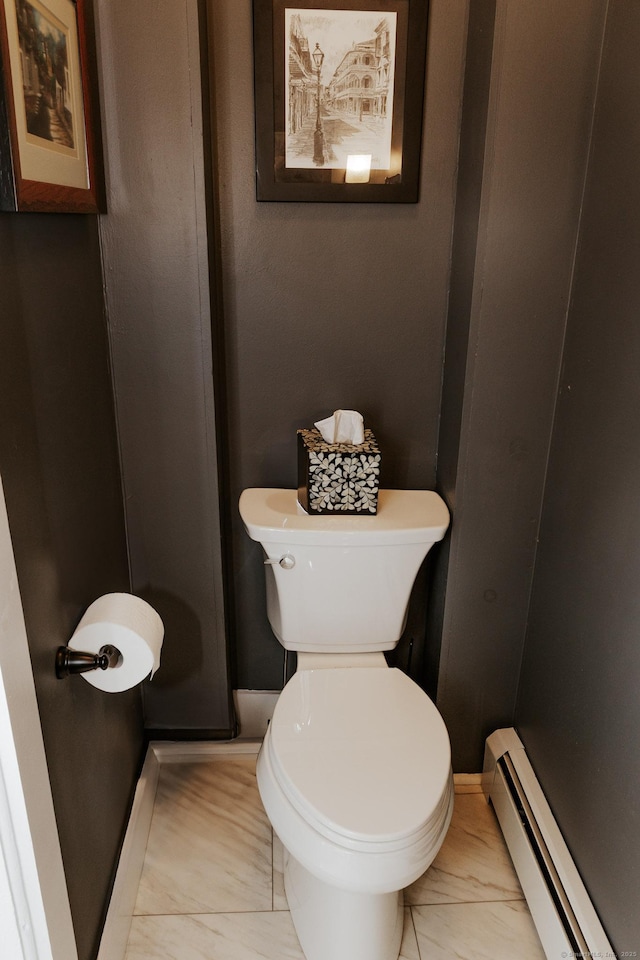 bathroom with toilet and a baseboard heating unit