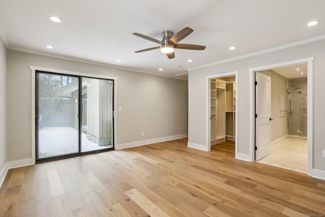 empty room with ceiling fan, ornamental molding, and light wood-type flooring