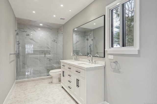 bathroom featuring vanity, toilet, and an enclosed shower