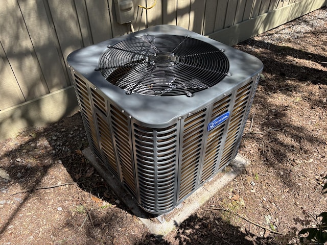 details with central AC unit and board and batten siding