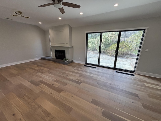 unfurnished living room featuring baseboards, a ceiling fan, light wood-style floors, and recessed lighting