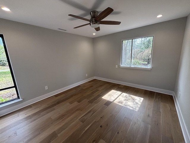 spare room with recessed lighting, dark wood finished floors, visible vents, a ceiling fan, and baseboards
