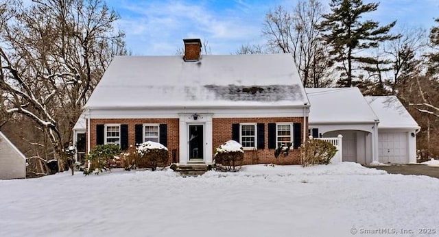 cape cod-style house featuring a garage