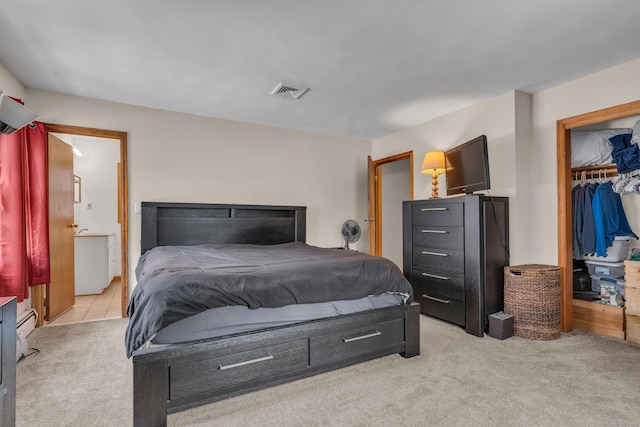 bedroom with a spacious closet, light carpet, and a closet