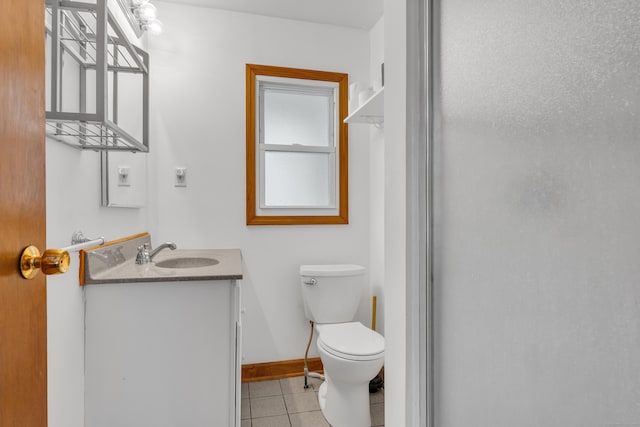 bathroom with vanity, toilet, and tile patterned flooring