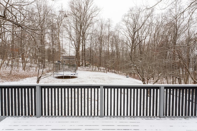 snow covered deck featuring a trampoline