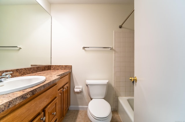 full bathroom featuring bathing tub / shower combination, toilet, vanity, and tile patterned flooring