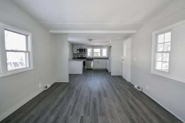 unfurnished living room featuring dark hardwood / wood-style floors