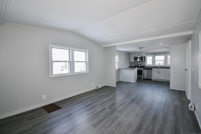 unfurnished living room featuring vaulted ceiling, dark wood-type flooring, and sink