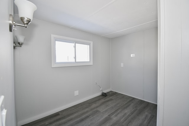 unfurnished room with dark wood-type flooring