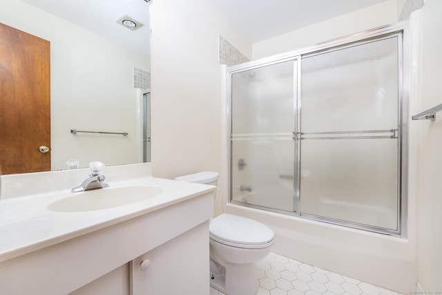 full bathroom featuring shower / bath combination with glass door, vanity, and toilet