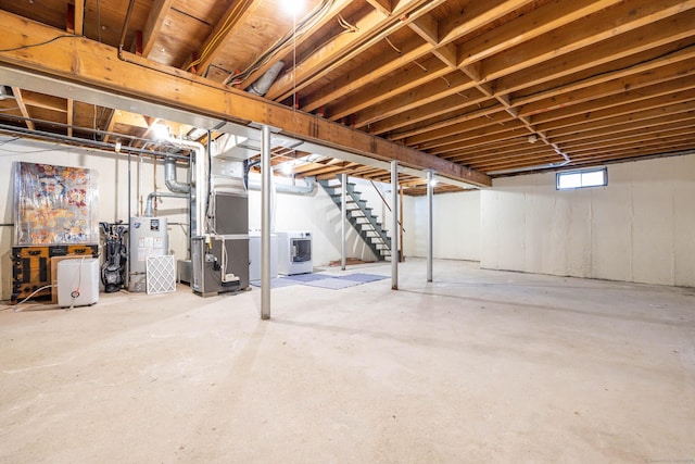 basement featuring washer / clothes dryer, heating unit, and gas water heater