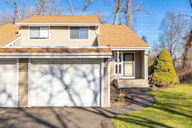 view of front of house featuring a garage and a front yard