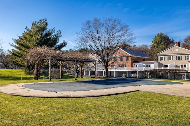 view of swimming pool featuring a lawn