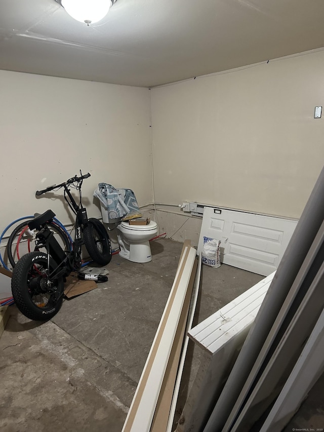 bathroom with concrete floors and toilet