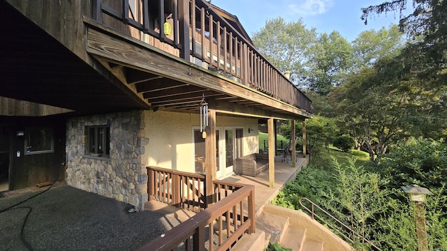 wooden terrace with a patio area