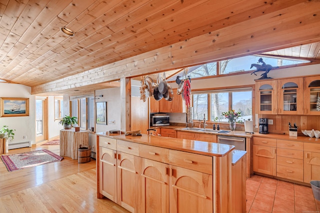 kitchen with a baseboard heating unit, a kitchen island, light countertops, dishwasher, and glass insert cabinets