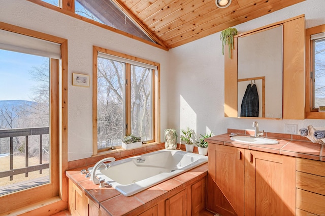 full bathroom with vaulted ceiling, a tub with jets, wooden ceiling, and a wealth of natural light